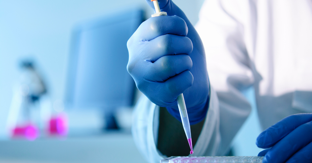 A scientist squeezing sample liquid into test tubes