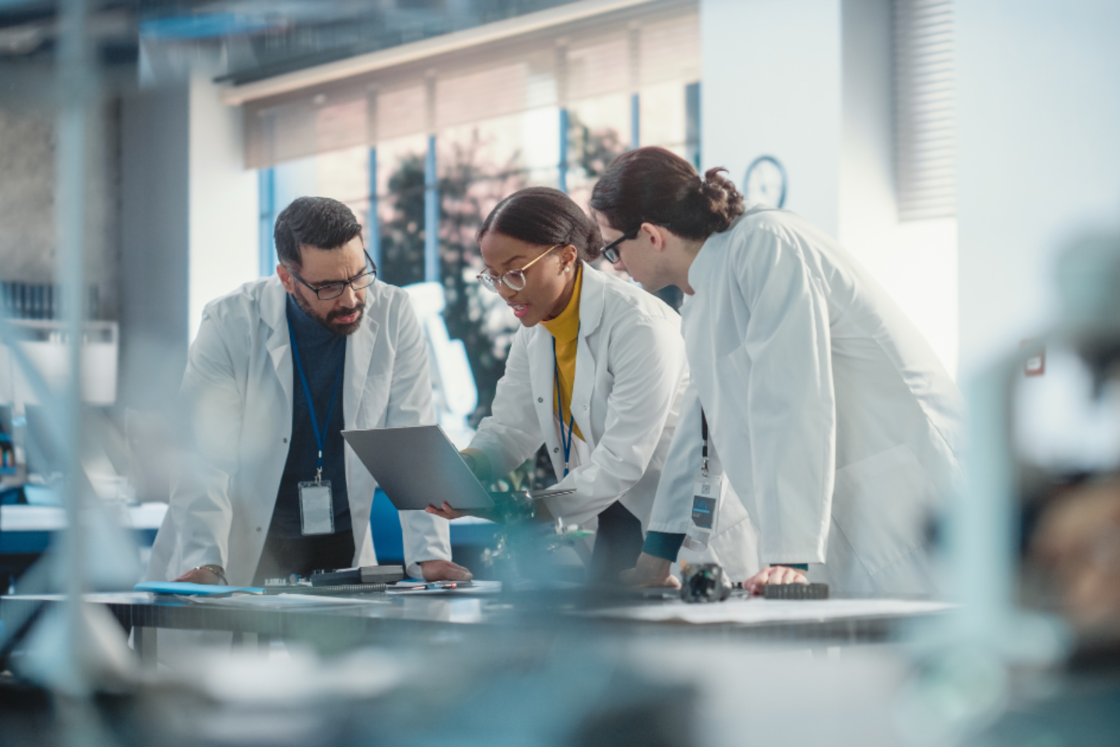 A group of scientists observing results on a laptop
